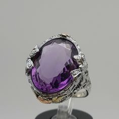 Antique Estate 14k Tri Gold Amethyst Filigree Ring  with Appraisal  Size 6  Item w#251 a true masterpiece of craftsmanship and elegance. This extraordinary ring is a testament to the timeless beauty of antique jewelry. Every detail of this ring has been masterfully crafted, resulting in an intricate and delicate filigree setting that exudes charm and sophistication. Adorning the setting is a captivating rose gold rose bud with yellow gold leaves on each side, evoking a sense of nature's beauty. Formal Amethyst Gemstones With Gemstone Accents, Formal Amethyst Gemstones With Accents, Elegant Multi-stone Amethyst Collectible Ring, Formal Purple Amethyst Ring With Gemstone Accents, Oval Purple Amethyst Ring For Formal Occasions, Oval Purple Amethyst Ring With 17 Jewels, Formal Purple Multi-stone Amethyst Ring, Purple Multi-stone Jewelry For Formal Occasions, Formal Purple Multi-stone Jewelry