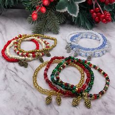 "These delicate Christmas/winter theme stretchy stackable bracelets are handcrafted personally for me, Derlis. You can pick your size bracelet and your favorite set of 4 bracelets each or get them individually. Perfect Christmas and New Year gift for kids and adults alike, love ones, friends, family, coworkers. It is very important that you measure your wrist before placing your order to find your correct size bracelet. You can use a flexible tape measure, or a piece of paper, or shoe string, wr Winter Bracelet, Winter Jewelry, Christmas Bracelet, Bracelet Design, Christmas Charms, Silver Line, Stackable Bracelets, Seeded Glass, Beaded Hoops