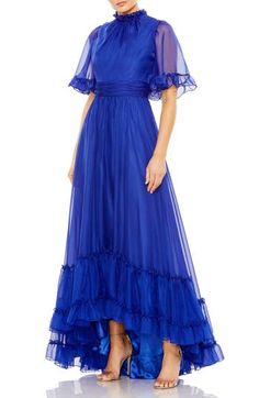 A brilliant blue gown serves so much swish from the frilly, full sleeves to the ruffle-decked, high-low hemline Ruffled jewel neck Short sleeves Lined, except sleeves 100% polyester Spot clean Imported Asian Owned/Founded Blue Ruffled Evening Dress For Gala, Blue Ruffled Maxi Length Evening Dress, Long Sleeve Gown With Ruffles, Blue Floor-length Gown With Ruffles, Blue Maxi Gown With Ruffles, Blue Ruffled Maxi Length Gown, Blue Wedding Dress With Ruffle Hem, Royal Blue Ruffled Evening Dress, Blue Ruffled Gown For Gala