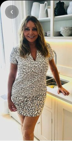 a woman standing in front of a kitchen counter