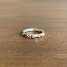 a silver ring sitting on top of a wooden table