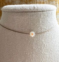 So simple and sweet. Features a floating,tiny mother of pearl daisy, nylon cord. Select length on the menu. Let me know if you would like a 2" extension  on note to seller at checkout. The necklace will be gift boxed. Minimalist White Jewelry For Spring, Cute Adjustable Choker Jewelry, Minimalist Adjustable Choker For Summer, Dainty Adjustable Summer Necklaces, Handmade Dainty Necklace For Spring, Dainty Adjustable Spring Jewelry, Dainty Necklace For Spring Gift, Dainty Spring Jewelry With Flower Charm, Handmade Spring Necklaces In Cute Style