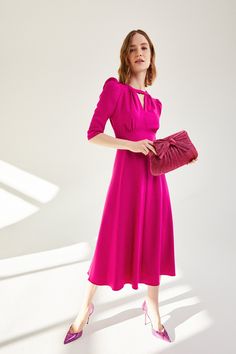 A beautiful 1940s-inspired midi dress cut from a high quality Italian stretch wool faille with stretch silk lining throughout the bodice and skirt. The bodice features an exquisitely cut neckline, with perfectly positioned gathering detail and front keyhole. A shaped underbust panel gives structure to the waist and creates a flattering empire line seam to lift and enhance the bust. A soft bias cut skirt falls from the waist seam to mid calf length. The neat raglan sleeve, that finishes just belo Feminine Fitted Tea Length Dress For Formal Occasions, Classic Midi Dress With Fitted Bodice For Dinner, Formal Midi Dress With Gathered Neckline, Feminine Midi Dress With Flattering Silhouette For Evening, Semi-formal Midi Dress With Fitted Bodice, Feminine Flattering Midi Dress For Evening, Elegant Formal Midi Dress With Bust Darts, Workwear Midi Dress With Pleated Fitted Bodice, Midi Dress With Pleated Bodice