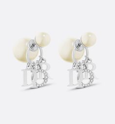 The Dior Tribales earrings offer a new variation on an iconic House style. The white resin pearls are embellished with D.I.O.R. letters in silver-finish metal, with the letter O in a pavé of white crystals. The bold earrings can be paired with other styles from the Dio(r)evolution line.. Dior Earrings, Jeweled Earrings, Bold Earrings, White Crystals, Letter Charms, Earrings Silver, Hair Jewelry, Pearl White, The White