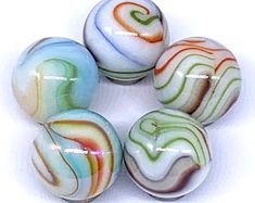 five glass marbles sitting on top of each other