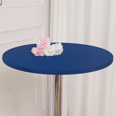 a blue table with a flower on it