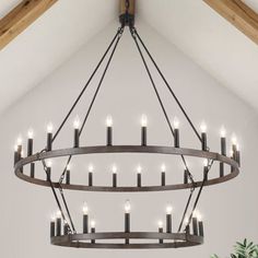 a chandelier hanging from the ceiling in a room with white walls and wooden beams