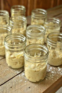 several jars filled with food sitting on top of a wooden table