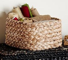 a basket sitting on top of a table next to a pile of books and other items