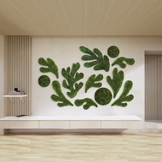 a living room with white walls and wooden flooring is decorated with green plants on the wall