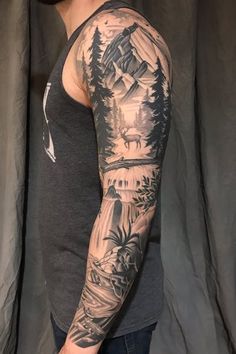 a man's arm with mountains and trees on it