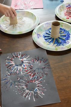 children are making paper plates with fireworks on them