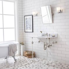 a bath room with a tub a sink and a window