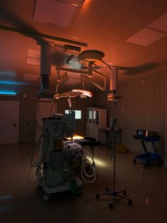 an operating room with lights and equipment in it