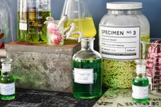 some bottles and containers filled with liquid on a table