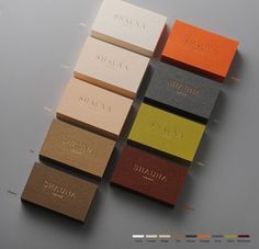 five different colored business cards sitting on top of each other