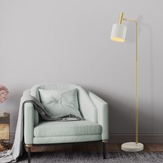 a living room with grey walls and a light blue chair next to a white lamp