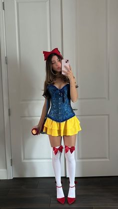 a woman in a costume is taking a selfie