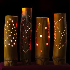 three decorative vases with lights on them