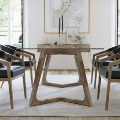 a glass table with chairs around it in front of a large painting on the wall