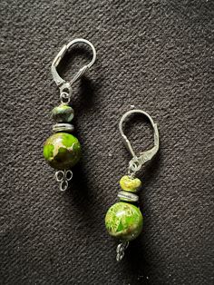 Featuring stunning rainbow agate stones complemented by elegant Sterling silver accents, these earrings hang delicately at 1 inch with secure lever back closures. Artisan Drop Earrings With Lever Back Ear Wires, Elegant Green Agate Earrings, Artisan Silver Earrings With Natural Stones, Unique Nickel-free Agate Jewelry, Green Agate Dangle Earrings, Green Agate Drop Earrings, Unique Silver Agate Earrings, Green Sterling Silver Jewelry With Lobster Clasp, Elegant Silver Agate Earrings