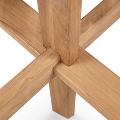 a close up view of the top of a wooden table with four intersecting pieces on it