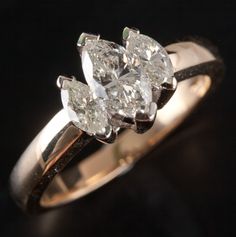 three stone diamond ring on black background