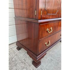 a large wooden dresser sitting on top of a carpeted floor