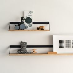 two wooden shelves with black and white striped wallpaper