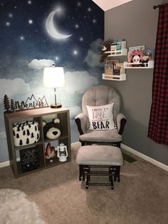 a child's room with a chair, bookshelf and wall mural