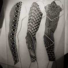 three black and white tattoos on paper