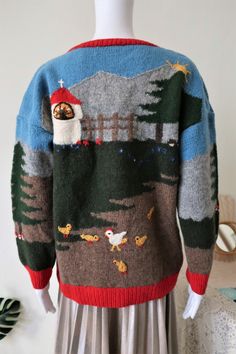 One of a kind True Vintage handmade sweater from Austrian trachten designer Ortrud Rainer. Superb quality wool knit with a whimsical countryside scenery. Embroidery and intarsia allover, depicting a mountainous landscape with a chapel, trees, flowers, mushrooms, a fence and chickens with chicklets enjoying life. Red collar, cuffs and waistband. 'Rainer' label embroidery on the left clavicle. Straight cut, crew neck. We love the blue blue sky with the sun going up behind the mountains Handmade in Scenery Embroidery, Countryside Scenery, Landscape Embroidery, Unique Cardigan, Mountainous Landscape, Highwaist Jeans, Wool Knit Sweater, Handmade Sweater, Enjoying Life