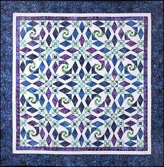 a blue and white quilt with swirls on it