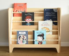 there are many books on the wooden shelf