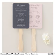 two wooden utensils with wedding programs on them