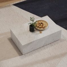 a white table with a bowl of food on it