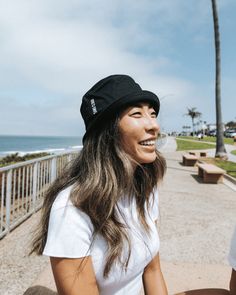 Introducing the Sand Cloud Bucket Hat, a must-have for your sunny adventures. This hat features a beautifully embroidered white Sand Cloud logo and a stylish 2-inch flap, perfect for adding both flair and sun protection to your look. Made from 100% cotton; fits most. Approx size : 56cm Women's Fit Color : Black Bucket Hat Unisex with Flat Sand Cloud Round Icon Embroidery in White 100% Cotton Made in China Care Details: Machine Wash Cold Delicate Cycle Do Not Bleach Hang Air Dry Do Not Iron Do No Cotton Brimmed Dad Hat For Beach, Summer Cotton Brimmed Trucker Hat, Cotton Brimmed Trucker Hat For Summer, Summer Brimmed Cotton Trucker Hat, Travel Bucket Hat With Upf 50+, Brimmed Dad Hat For Summer Beach, Cotton 5-panel Trucker Hat For Beach, Casual 5-panel Bucket Hat With Upf 50+, Upf 50+ Brimmed Baseball Cap For Beach