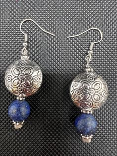 Beautiful antique silver bead with a sketch of a flower. Next there is a blue bead which gives this earring it's q unique style. Blue Sterling Silver Flower Earrings Nickel Free, Vintage Silver Beaded Earrings Nickel Free, Traditional Blue Flower Jewelry, Blue Earrings With Silver Beads, Silver Flower Beaded Earrings As Gift, Handmade Silver Beaded Flower Earrings, Blue Sterling Silver Earrings With Silver Beads, Silver Flower Beaded Earrings For Gift, Handmade Silver Flower Beaded Earrings