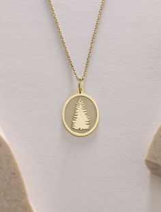 Gold Evergreen Tree Pendant - Tree of life Gold Necklace ● Material of pendant: Solid Gold 14k ( REAL GOLD ) ● Metal Stamp: 14k ( REAL GOLD ) ● The pendant is available in 5 sizes: - 12x17 mm / 0,47 x 0,66 inches - 13x18 mm / 0,51 x 0,70 inches  In the photos - 14x19 mm / 0,55 x 0,74 inches  - 16x21 mm / 0,62 x 0,82 inches  - 18x24 mm / 0,70 x 0,94 inches ( In the photos the size is 13x18 mm / 0,51 x 0,70 inches ) ( Jump Ring inner diameter: 4 mm ) ● Material of chain: Solid gold 14k ( REAL GOLD ) It is thin and dainty and it is available in 4 sizes: - 40 cm / 15,75 inches ( Length ) - 45 cm / 17,72 inches ( Length ) In the photos - 50 cm / 19,68 inches ( Length ) - 55 cm / 21,65 inches ( Length ) ● Backside engraving is FREE ( Please use the personalization box for that.) ● If you want la Tree Pendant Necklace, Symbolic Gold Jewelry With Tree Of Life, 14k Gold Tree Of Life Jewelry Gift, Golden Tree Necklace, Tree Of Life Pendant Gold, Gold Tree, Tree Necklace, Evergreen Trees, Tree Pendant