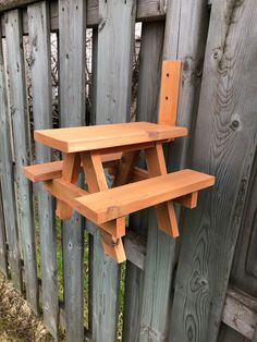 a wooden bench sitting on top of a wooden fence