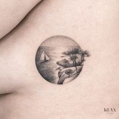 a woman's breast with a landscape tattoo on it