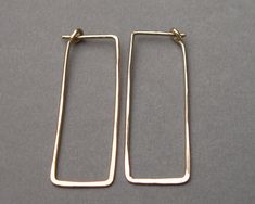 "These simple geometric dangles are shaped to easily insert and have a self closure for security. They're so comfortable you can wear them 24/7, and they go with anything. Hammered for hardness, these 19 gauge earrings are effortless and comfortable. Choose your metal and length in dropdown menu. 1 inch x 3/8\" or 1 1/2 inches x 1/2\". Made to order. Shipping ~ Domestic orders are sent USPS insured first class. Expect 3 to 5 business days for delivery from the date it is mailed. I am a 1-person Minimalist Hammered Rectangular Earrings, Everyday Hammered Rectangular Jewelry, Silver Wire Earrings, Rectangular Earrings, Gauge Earrings, Artisan Bracelets, Gold Filled Hoops, Gauged Earrings, Contemporary Minimalist