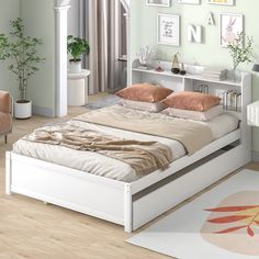 a white bed sitting on top of a wooden floor