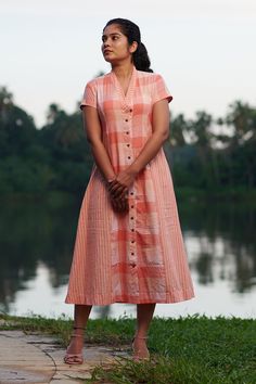 "Collar V necked, shaped shirtdress in peach stripes & checks Length - 40 inches Height of model - 5'4\" / 163cm Measurements of model - 33.5 inch (bust) 28 inch (waist) 40 inch (hip) Model wears a size XS Colour - Peach Fabric - 100 % Cotton Slightly sheer COMPOSITION 100% pure cotton medium weight locally woven GARMENT MEASURE IN INCHES XS Chest - 36\" / 91 cm Waist - 32\" / 81 cm Hips - 41\" / 104 cm Length - 40\" / 102 cm S : Chest - 39\" / 99 cm Waist - 35\" / 89 cm Hips - 44\" / 112 cm Len Cotton Frocks For Women, Cotton Dress Pattern Indian, Western Frocks, Saraswati Picture, Collar Kurti Design, Simple Frock, Frock Models, Cotton Dress Pattern, Simple Frock Design