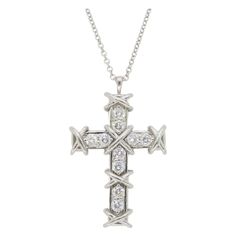 Never worn iconic Tiffany & Co. Schlumberger ten diamond cross necklace made in Platinum, that comes with original box, as shown in images. Diamond Carat Weight: Approximately .35CTW Diamond Cut: Round Brilliant Color: Average D-E Clarity: Average VVS2-VS1 Metal: Platinum Chain Length: 16” Long Pendant Length: 1 1/8” Long Marked/Tested: Stamped "T& CO" "SCHLUMBERGER STD" "PT950" Weight: 6 Grams Tiffany Cross, Jean Schlumberger, Diamond Cross Necklace, Stone Cross, Platinum Chain, Tiffany Co Jewelry, Diamond Cross, Tiffany And Co, Cross Jewelry