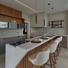 a kitchen filled with lots of counter top space and white stools next to an island