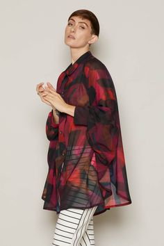 Introducing the stunningly versatile Brooke blouse, a true epitome of elegance and adaptability in fashion. Printed on eco-friendly recycled chiffon, this shirt boasts a breath-taking digitally printed design in fiery red hues, creating an absolute standout piece. The unique batwing sleeves, gracefully attached to the sides of the shirt, add an unconventional yet chic touch to its oversized silhouette. This shirt is a true chameleon in your wardrobe - it can be effortlessly styled in numerous ways! Wear it casually over a bikini for a relaxed beachside look, or pair it elegantly with trousers or a skirt for a fashion-forward ensemble. Its fully button-up design offers flexibility in styling, ensuring versatility in every wear. Embrace its inclusivity with sizing options ranging from XS to Take A Breath, Fiery Red, Oversized Silhouette, Batwing Sleeve, Bat Wings, Printed Design, In Fashion, Fashion Forward, Eco Friendly