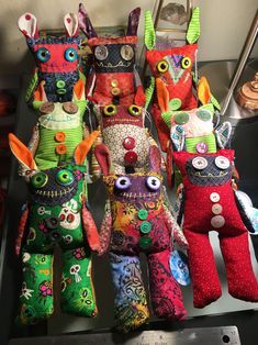 several colorful stuffed animals sitting on top of a table