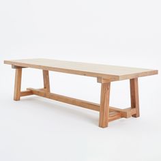 a wooden bench sitting on top of a white floor