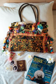 "This charming tote bag for lazy days at the beach and wandering around. It is made with an amazing piece of fabric woven by the HMONG hill tribes of Lanna Region (Northern Thailand). It features cotton lining, leather straps, a zipper closure and adorned with colorful hairs, pom poms. This bag will enhance your appearance. We buy materials from Hmong market and we design and sew by hand. Some of the bags we modify to improve the product. The Hmong tribes live in the North of Thailand and have o Bohemian Pouch Bags For Vacation, Bohemian Hobo Bag For Beach Season Travel, Embroidered Tote Shoulder Bag For Beach, Summer Bohemian Hobo Pouch Bag, Bohemian Summer Hobo Bag In Pouch Shape, Bohemian Summer Pouch Hobo Bag, Bohemian Rectangular Hobo Bag For Beach Season, Bohemian Brown Hobo Bag For Beach Season, Bohemian Rectangular Hobo Bag For Vacation